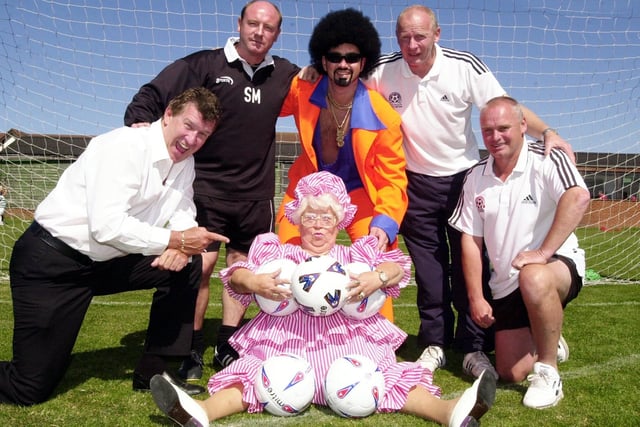 This photo was taken in 2003 and depicts a Celebrity Football Spectacular at Blackpool FC's training ground. Tony Jo is pictured left with BFC manager Steve McMahon, Lionel Vinyl, community officer for BFC Derek Spence, ex Blackpool footballer Dave Tong,  and at the front is Mo Moreland.