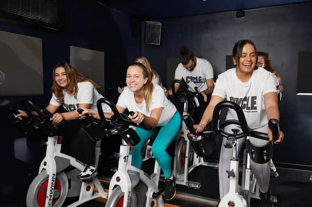 A team of five cyclists take to exercise bikes to complete their challenge for last year's Cycle for Smart Works.