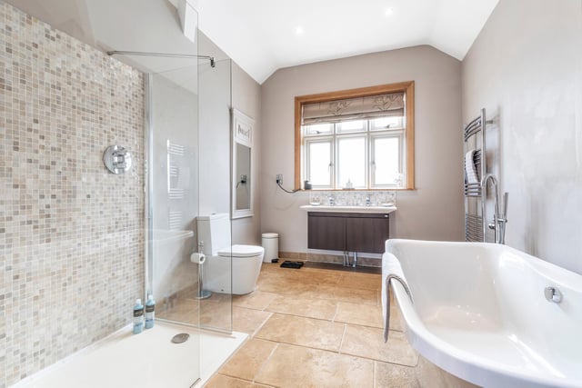 The family bathroom is a beautiful space with a walk-in shower and standalone bath.