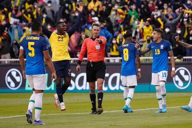 EPIC CLASH: Leeds United's Brazilian star winger Raphinha, right, gestures to referee Wilmar Roldan as he points to the spot only to then change his mind in a crazy 1-1 draw against Ecuador. Photo by SANTIAGO ARCOS/POOL/AFP via Getty Images.