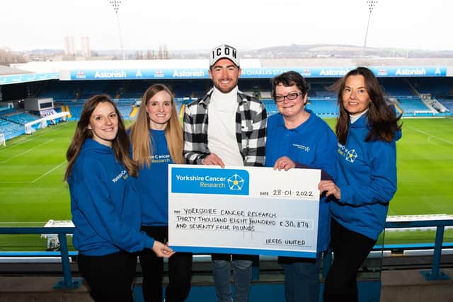 Leeds United's Jack Harrison at Elland Road with Yorkshire Cancer Research representatives.. Pic: Leeds United
