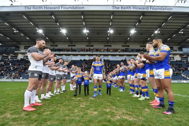Both teams give Tom Briscoe a guard of honour as he enters the field, with his children, ahead of his testimonial game. Picture by Matthew Merrick.