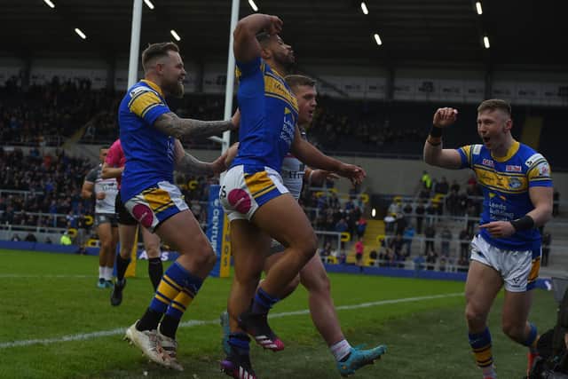 Kruise Leeming, centre, celebrates his try in Rhinos' pre-season win over Hull. Picture by Matthew Merrick.