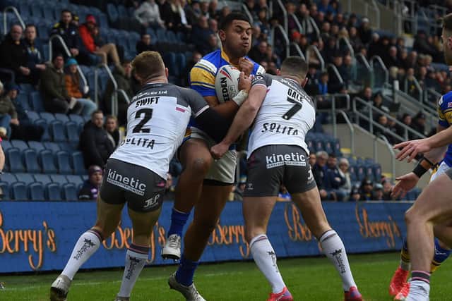 Rhinos winger David Fusitu'a, in his first appearance for the club, takes on Hull's Adam Swift and Luke Gale. Picture by Matthew Merrick.