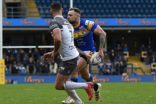Rhinos' Blake Austin looks to pass as Luke Gale closes in. Picture by Matthew Merrick.