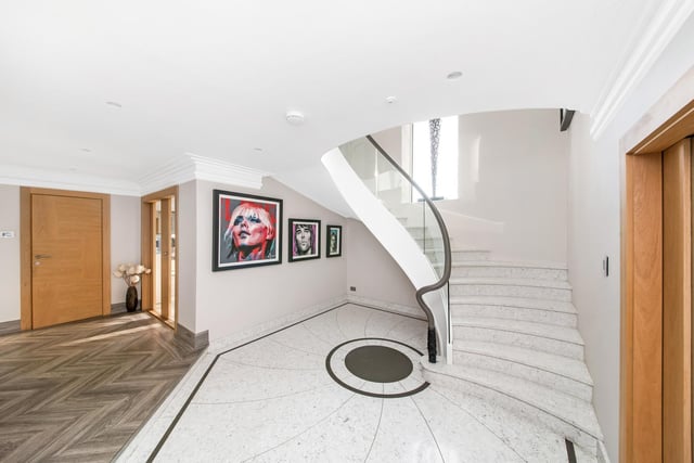 The striking entrance hall and staircase within the property.
