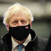 Prime Minister Boris Johnson wears a face mask during a visit to RAF Valley in Anglesey, North Wales, as No 10 braces for the submission of Sue Gray's report into possible lockdown breaches (Photo: PA Wire/Carl Recine)