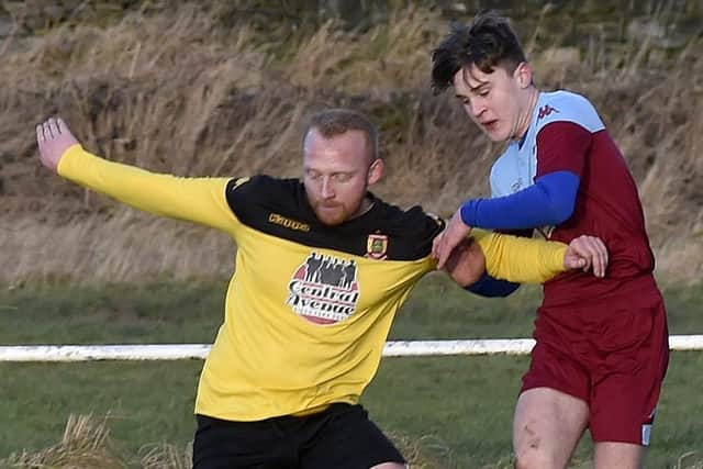 Aberford Albion's Rob Field tries to keep Jai Rigby, of  Rawdon OB, at arm's length during his side's 2-0 West Yorkshire League Cup reverse at their Leeds-area hosts. Picture: Steve Riding.