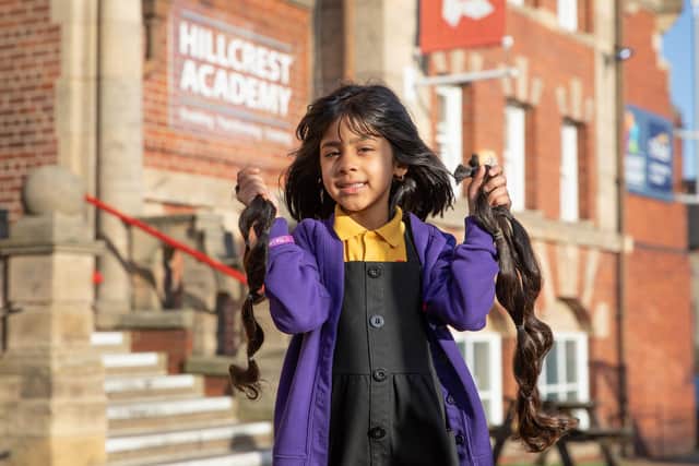 Hira-Noor Rashid, aged six shows off her new haircut at Hillcrest Academy near Harehills.