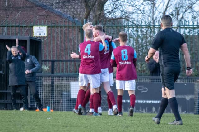 Emley players celebrate with goal scorer George Doyle. Picture: Mark Parsons