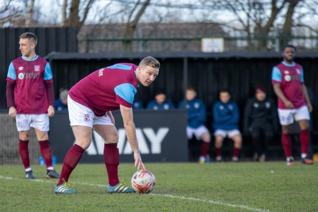 Emley captain Tom Claisse puts the ball on the centre spot ready to kick off. Picture: Mark Parsons