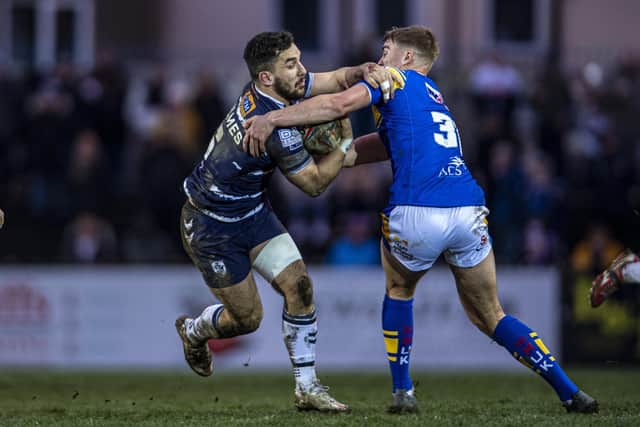 Oli Field, right, gets to grips with Tom Holmes during Rhinos' pre-season win at Featherstone. Picture by Tony Johnson.
