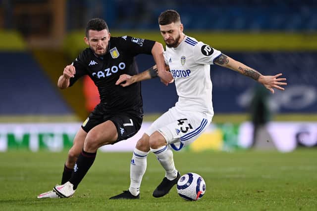 John McGinn and Mateusz Klich tussle for the ball during Leeds United's 1-0 defeat to Aston Villa in February 2021. Pic: Laurence Griffiths.