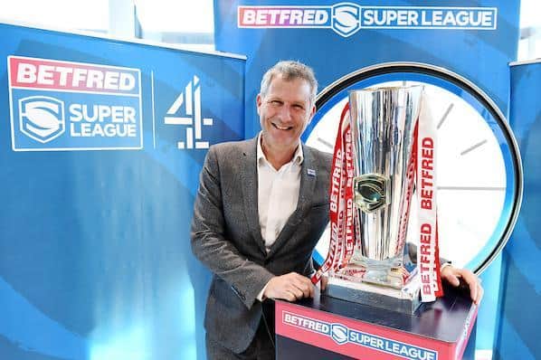 Adam Hills and the Super League trophy at Channel 4's headquarters in Leeds. Picture by Simon Wilkinson/SWpix.com.