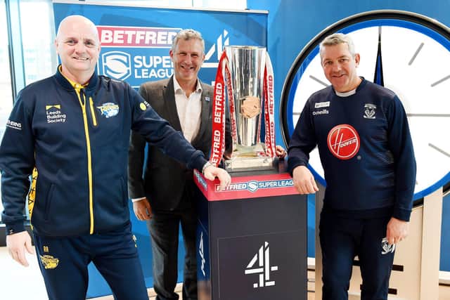 Leeds Rhinos head coach Richard Agar, left, and Warrington Wolves boss Daryl Powell, right, pose with presenter Adam Hills at this week’s Channel 4 launch. Picture: Simon Wilkinson/SWpix.com.
