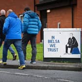 Leeds United supporters walk past a tribute to Marcelo Bielsa, painted by Andy McVeigh, on their way to Elland Road. Pic: Paul Ellis.