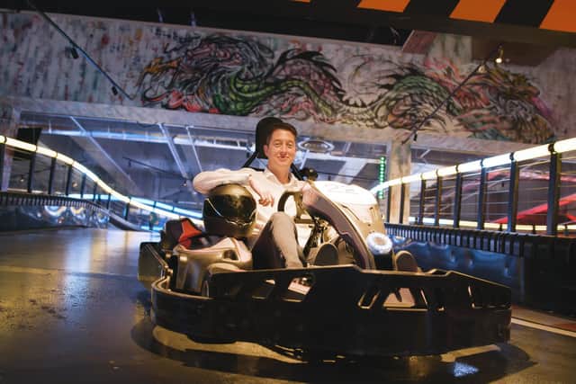 Gravity's co-founder and CEO, Harvey Jenkinson, in one of the state-of-the-art electric karts with Formula One steering wheels
