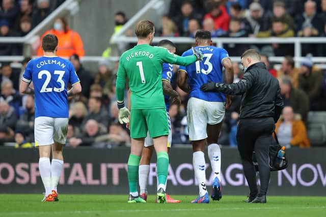 SETBACK: Everton's Yerry Mina, second right, is forced off injured during Tuesday night's 3-1 reverse at Newcastle United. Photo by Alex Livesey/Getty Images.
