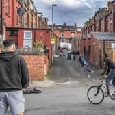 Young adults and children play street cricket in a back street off Hovingham Avenue, Harehills. Picture: Tony Johnson
