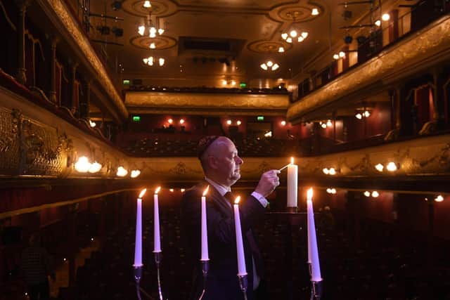 The Holocaust Memorial service at  Leeds City Varieties last month where Master of the Ceremony, Geoff Turnbull, lights a candle.