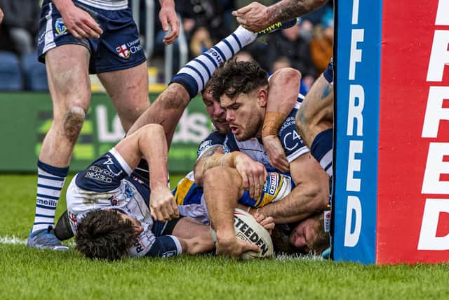 Leeds Rhinos' Matt Prior manages to ground the ball to score his side's second try against Warrington Wolves. Picture: Tony Johnson.