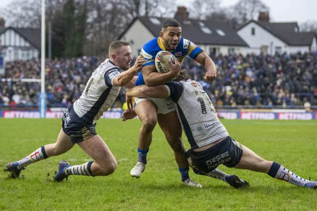Leeds Rhinos' Kruise Leeming is stopped in the closing moments by Warrington's Ben Currie and Ron Mulhern.  Picture: Tony Johnson.