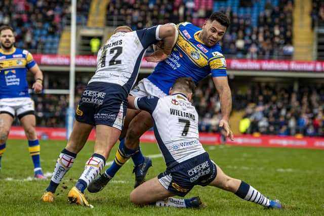 Rhyse Martin is tackled by Warrington's Oliver Holmes and George Williams.  Picture: Tony Johnson.