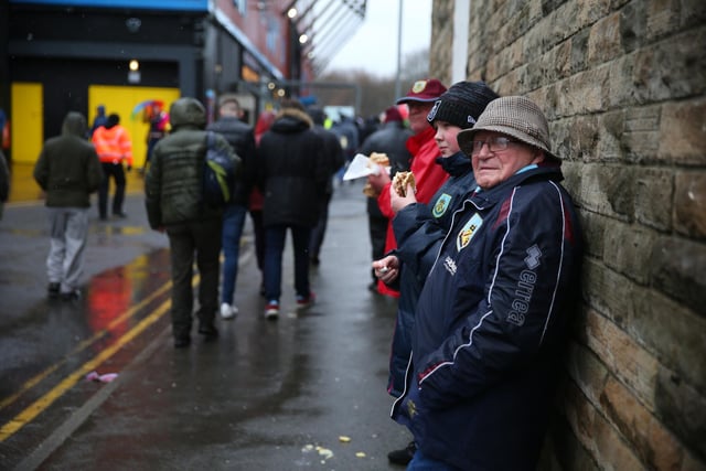 Fans of Burnley wait outside the stadium prior to the Premier League match between Burnley and Liverpool at Turf Moor on February 13, 2022 in Burnley, England.