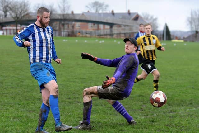 Liam Jordan scores for Western Juniors OB past Pudsey Bojangles goalkeeper Ash Raven. Pudsey went on to win the Luty Cup tie, 3-2. Picture: Steve Riding.
