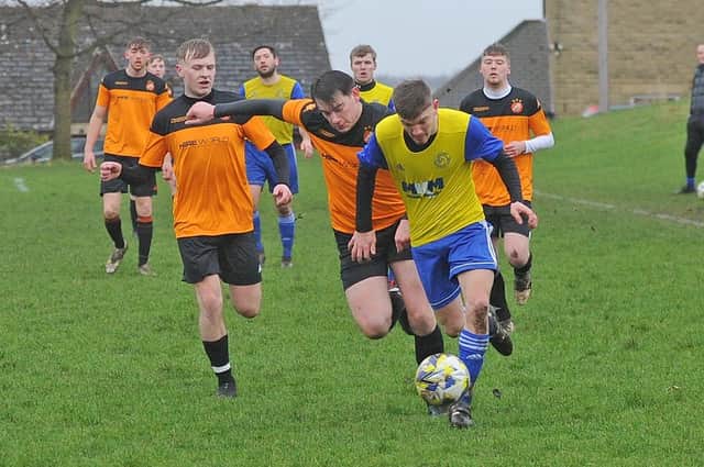 Harry Fryer, of Stanningley OB, hares down the wing chased by Nathan Rangeley of Colton Athletic Reserves. Stanningley came from two goals down to win this Yorkshire Amateur League Division fixture, 3-2. Picture: Steve Riding.
