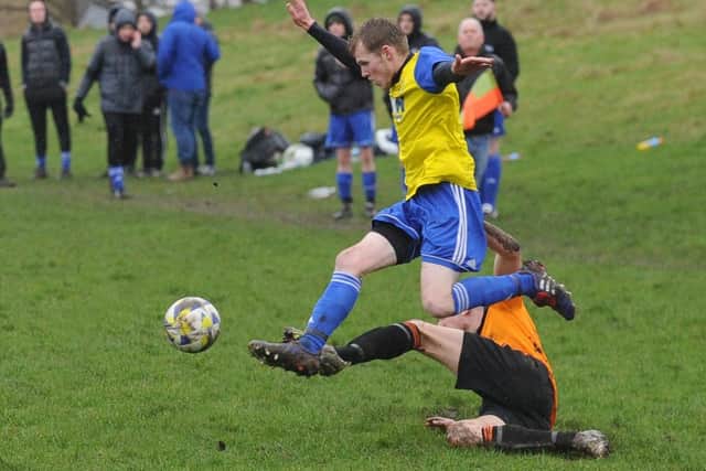 Stanningley Old Boys goalscorer Tom Crowther rides a tackle during Saturday's 3-2 Yorkshire Amateur League Division 3 win over Colton Athletic Reserves. Picture: Steve Riding.