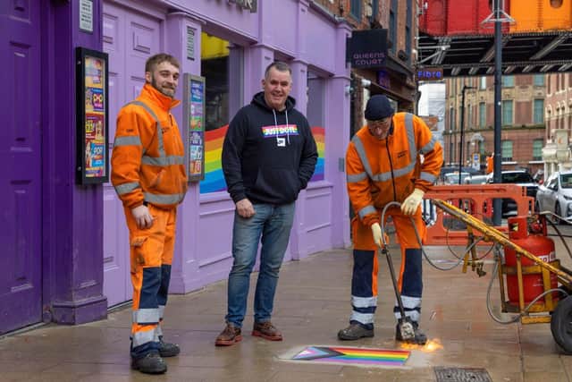 Pictured is Bar Fibre owner Terry George (centre) helping to lay one of 16 LGBT+ paving slabs commissioned by Leeds City Council. Photo: Jo Rendell