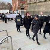 Protestors carried a coffin through Leeds city centre during the mock funeral