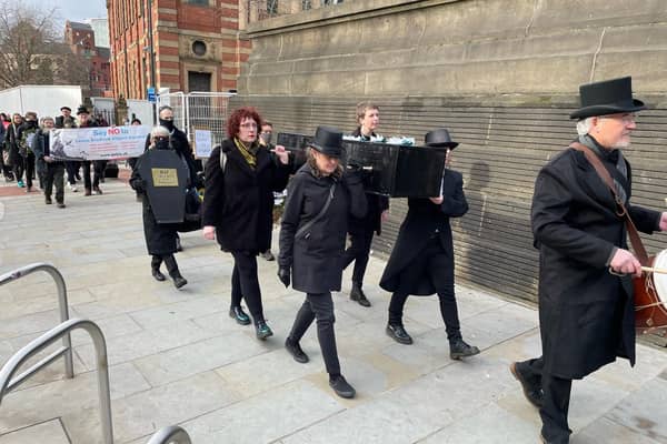 Protestors carried a coffin through Leeds city centre during the mock funeral