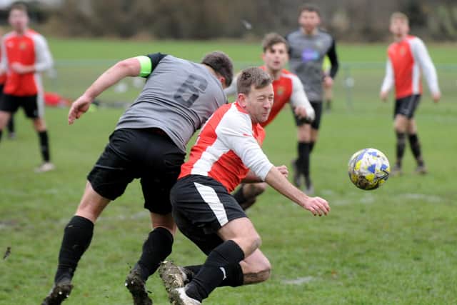 Chris Ward, of Old Centralians, heads goalwards under pressure from Tingley Athletic goalscorer Andy Conway. Picture: Steve Riding.