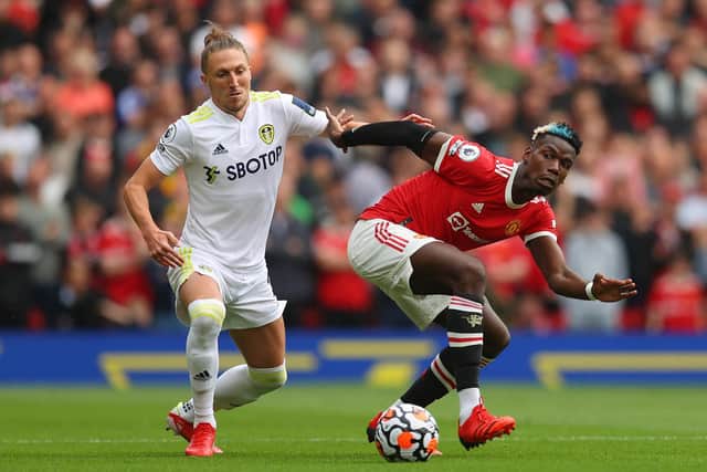 Luke Ayling and Paul Pogba vie for the ball during Leeds United's 5-1 defeat to Manchester United at Old Trafford in August 2021. Pic: Catherine Ivill.