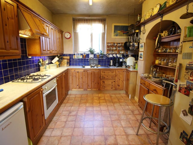A large character kitchen with plenty of storage and integral appliances inside this Scarborough home. (Exterior top photo.)