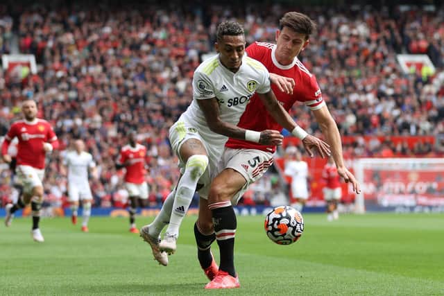 KEY PAIR: Leeds United's Brazilian international star Raphinha, left, is challenged by Manchester United captain Harry Maguire in August's clash between the Whites and Red Devils at Old Trafford. Photo by Catherine Ivill/Getty Images.