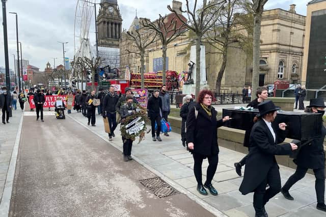 Extinction Rebellion and GALBA protesters stage a mock funeral for the city's carbon budget.