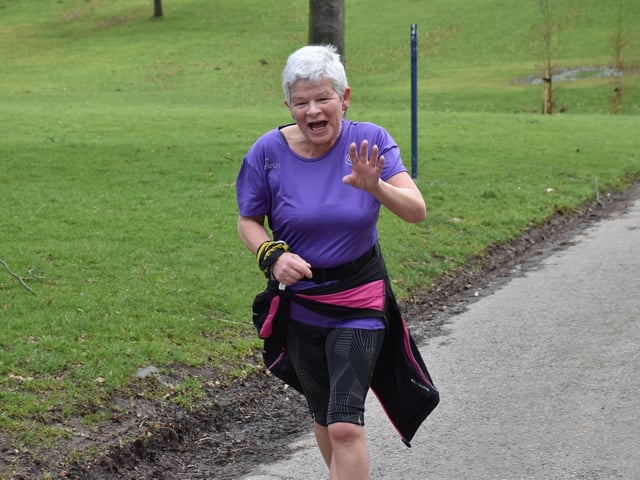 A runner takes time out to smile and wave at the photographer
Photo by TCF Photography