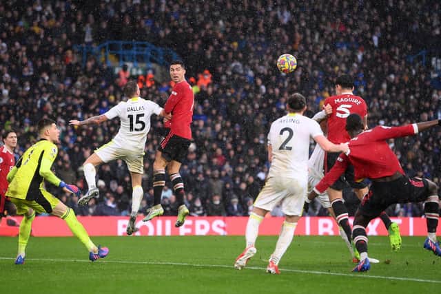 OPENER: Harry Maguire beats Diego Llorente, far side, to head Manchester United in front in Sunday's Premier League clash against Leeds United at Elland Road. Photo by Laurence Griffiths/Getty Images.
