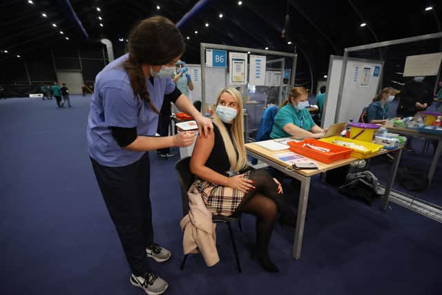 Pauline LaMon receives her booster jab at a COVID-19 booster vaccination centre at the Titanic Exhibition Centre in Belfast. Photo: PA