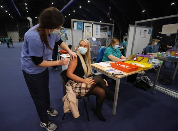 Pauline LaMon receives her booster jab at a COVID-19 booster vaccination centre at the Titanic Exhibition Centre in Belfast. Photo: PA