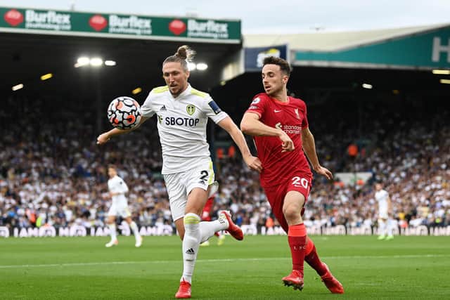 Luke Ayling and Diogo Jota vie for the ball during Leeds United's 3-0 defeat to Liverpool in September 2021. Pic: Shaun Botterill.
