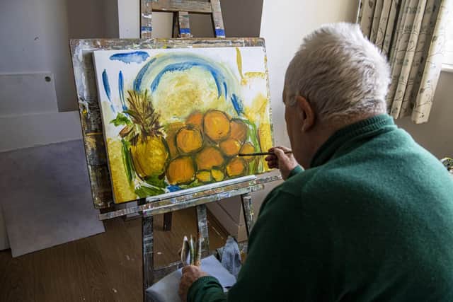 George pictured working in his studio in his home. Picture Tony Johnson.