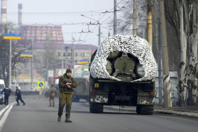 A Ukrainian soldier stands next to a military vehicle on a road in Kramatosrk, eastern Ukraine. Picture: AP Photo/Vadim Ghirda.