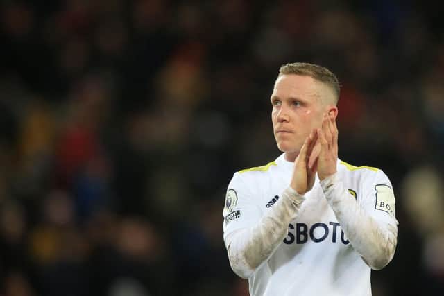 KEEPING POSITIVE: Whites midfielder Adam Forshaw applauds the fans after Leeds United's 6-0 hammering against Liverpool at Anfield, above. Photo by LINDSEY PARNABY/AFP via Getty Images.