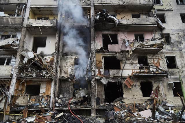 Firemen extinguish a fire inside a residential building that was hit by a missile in Kyiv, Ukraine. Yesterday, Russia began a large-scale attack on Ukraine, with Russian troops invading the country from the north, east and south, accompanied by air strikes and shelling.