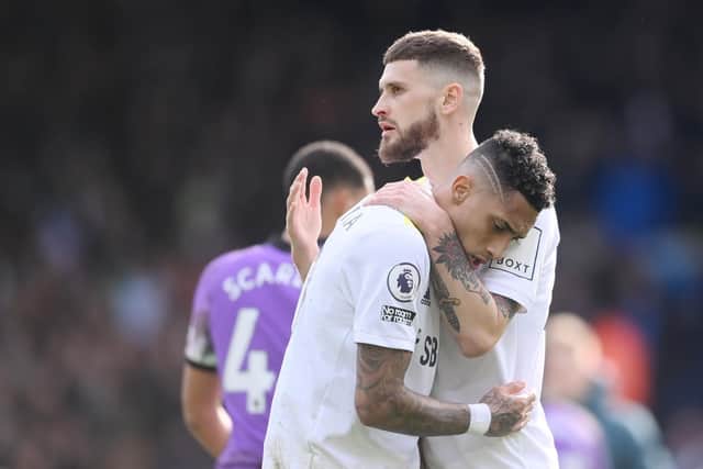 Mateusz Klich and Raphinha embrace during Leeds United's 4-0 defeat to Tottenham Hotspur. Pic: Laurence Griffiths.