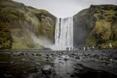 ICELAND: Tourists walk around Skogafoss waterfall. Photo: Getty Images